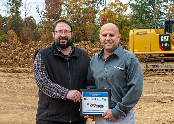 In a plaque presentation on the Allan Myers Field Site, Beishline (left) and Giumento cement a mutually beneficial collaboration. 