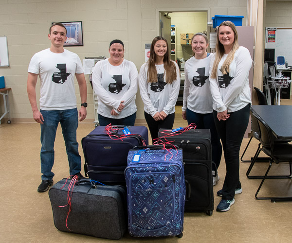 Students in Global Healthcare Explorations meet to go over last-minute instructions and weigh bags of donated items. From left: Jesse D. Laird V, of Chambersburg; Jordan Specht, of Frederick, Md.; Madison T. McClelland, of Columbia Cross Roads; Kylee D. Butz, of Lawrenceville; and Maci N. Ilgen, of Spring Mills. They will be joined in service by Christine B. Kavanagh, assistant professor of nursing, and Theresa Moff, a pediatric nurse practitioner for UPMC.