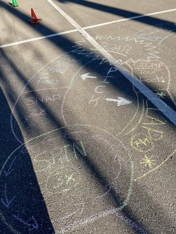 At the block party, a sidewalk chalk path guides children to perform physical, balance, coordinate, fine and gross motor as well as cognitive activities.