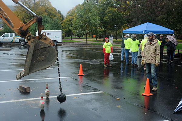 Unfazed by a rain-swept workspace, Seth J. Welshans monitors a knock-down exercise in the parking lot. Welshans, who holds two Penn College degrees, is a laboratory assistant for diesel equipment technology at the Schneebeli Earth Science Center.