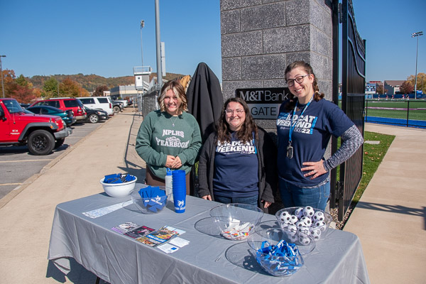 Amy Feaster (left), a North Penn-Liberty High School student doing a job shadow activity to learn more about event planning, joins Student Engagement assistant directors Jaycie M. Loud (center) and Meghan R. Delsite Coleman to share giveaways, information and a friendly welcome at the women’s soccer game.