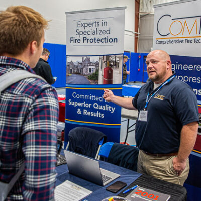 Electrical construction student Jake M. Braucher, of Mohrsville, talks with Rob Haberle, a senior project manager with Comprehensive Fire Technologies.