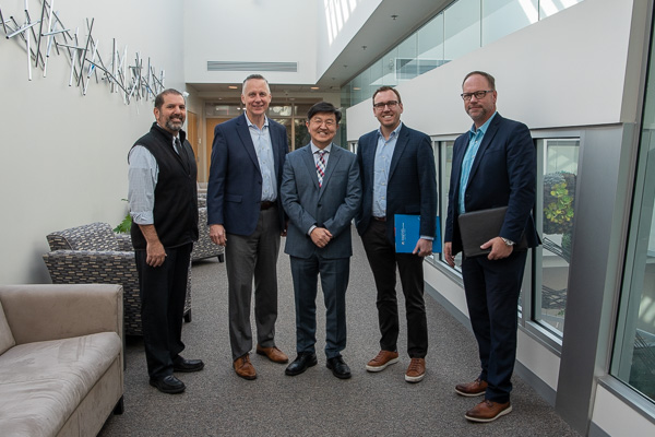 Prior to setting off on their wide-ranging campus tour, the visitors pause for a group photo with Penn College’s president on the third floor of the Davie Jane Gilmour Center. From left: Brennan, Reed, Ryoo, Gasbarre and Lashinsky. 