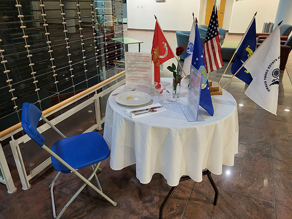 Across campus, as in the Davie Jane Gilmour Center, “empty table” displays pay silent tribute.