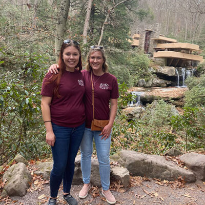 Ritter (left) and Oberlin stand outside Fallingwater, inhabiting the cantilevered structure's coalescence of art and nature.