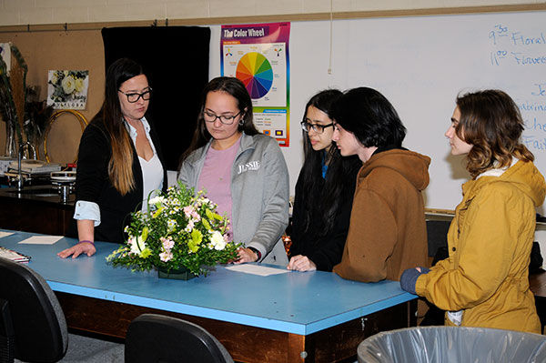 Evaluating a centerpiece as part of the Floral Design competition are landscape/horticulture technology: plant production emphasis alums (from left) Sabrina S. Baker, '18, and Jessica M. Duke, '20. Baker is employed by Dillon Floral in Bloomsburg, which donated flowers for the event; Duke's business – Jessie the Florist – is based in Allentown ...
