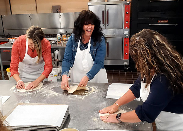 Adding a pinch of fun – an essential ingredient in most any dish – are (from left) Katie L. Mackey, assistant director of disability and access resources; Stacey J. Brown, manager of acaademic operations/student support; and Kimberly S. Cordrey, Lumley Aviation Center secretary.