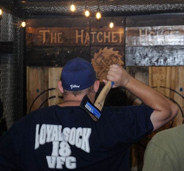 Student leader T.J Gilbert, of Blairsville, active on campus and off (including service to the Loyalsock Volunteer Fire Co.), prepares his toss at The Hatchet House's portable booth. Pursuing a bachelor's in residential construction technology and management, he will pick up an associate degree in building construction technology at Dec. 17 commencement.