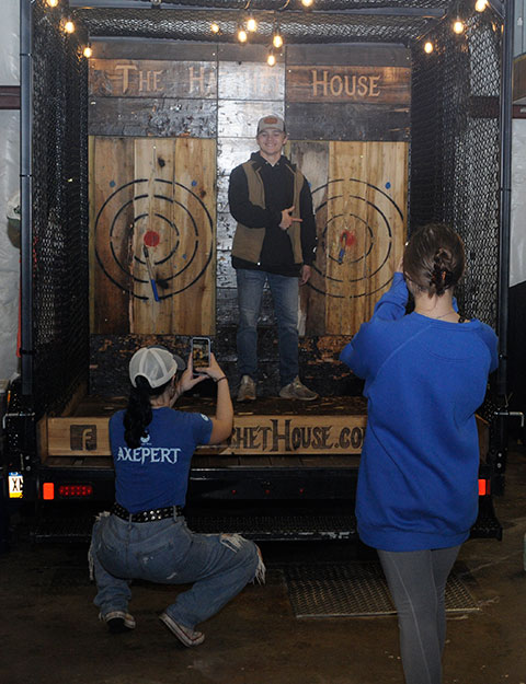 Cellphone cameras immortalize a bull's-eye thrown by Logan B. Westlake, of Bechtelsville, enrolled in electronics & computer engineering technology: robotics & automation emphasis. The Hatchet House shares owners with Dad's BBQ, which served chicken and mac 'n' cheese nearby.