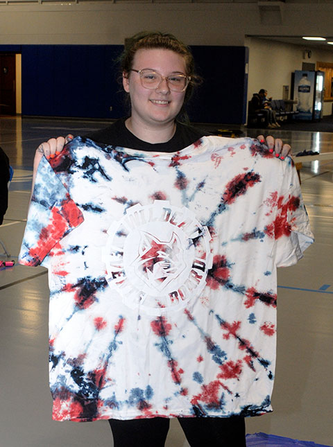 Benny displays the result of her craft: a colorful sunburst reflecting the evening's red, white and blue theme.