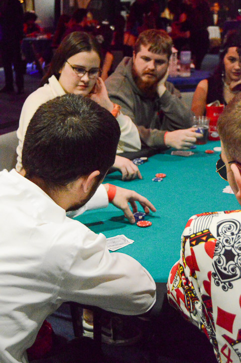 All eyes are on Nathan J. Ferrebee (in white shirt), of Pine Grove – a network administration & engineering technology student by day – as he explains poker rules, intricacies and subtleties for newer players at the table.