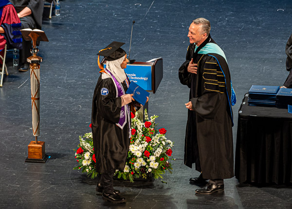 A literally heartfelt gesture conveys Reed's congratulations to Samar Alquraish, a nursing graduate who was also presented with the Board of Director's Award.