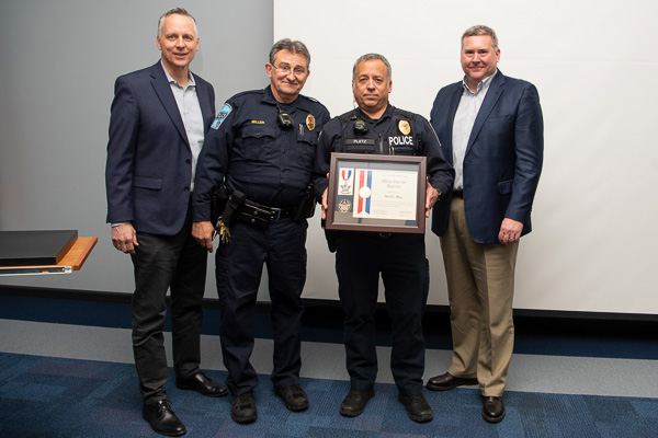Pennsylvania College of Technology Police Lt. David C. Pletz (holding plaque) has received national recognition for actions leading to the Sept. 28 apprehension of an armed suspect near campus. Among those on hand at an awards ceremony are (from left) Penn College President Michael J. Reed; Penn College Police Chief Chris E. Miller; and Elliott Strickland, vice president for student affairs. 