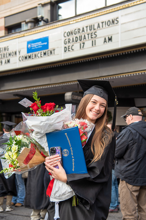 Madison T. McClelland earned a bachelor's in nursing ... and, judging from her keepsake-filled hands, a minor in juggling.