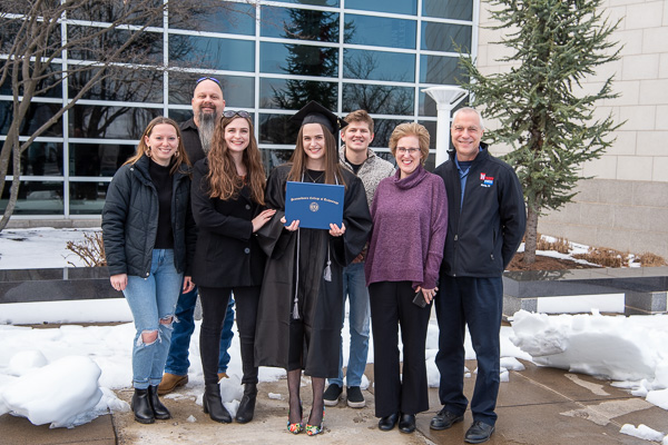 Human services & restorative justice alum Madison R. Clary, gathers with her family – including her father, Mark E. (rear left), a plumber with the college's General Services department – outside the Davie Jane Gilmour Center.