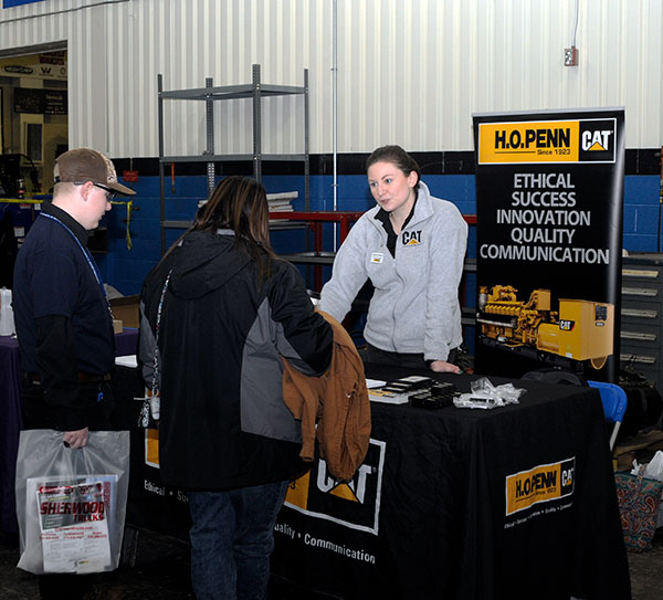 Kathryn Herbert, from H.O. Penn Machinery Co. – one of Penn College's historically supportive Caterpillar partners – talks with a family prior to the start of competition.