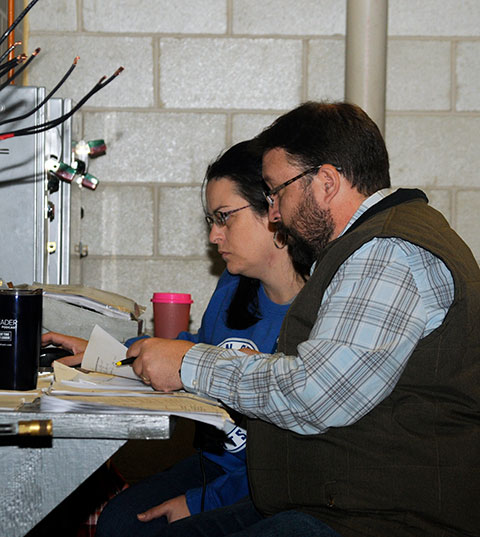 Painstakingly tabulating competitors' scores all day long for a thoroughly accurate spreadsheet of final results are Laura M. Machak, K-12 outreach specialist, and Justin W. Beishline, assistant dean of diesel technology and natural resources.