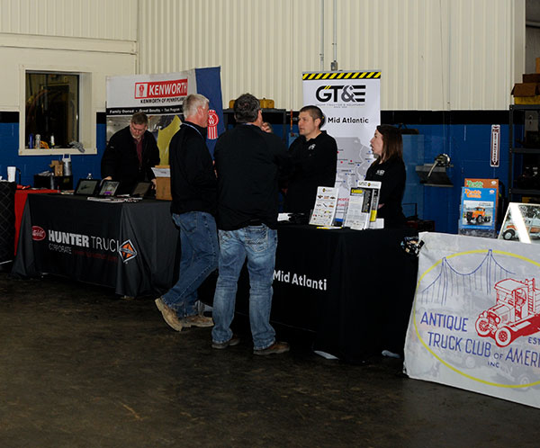 Adjacent to the competition space, corporate partners stand ready to chat with attendees ...