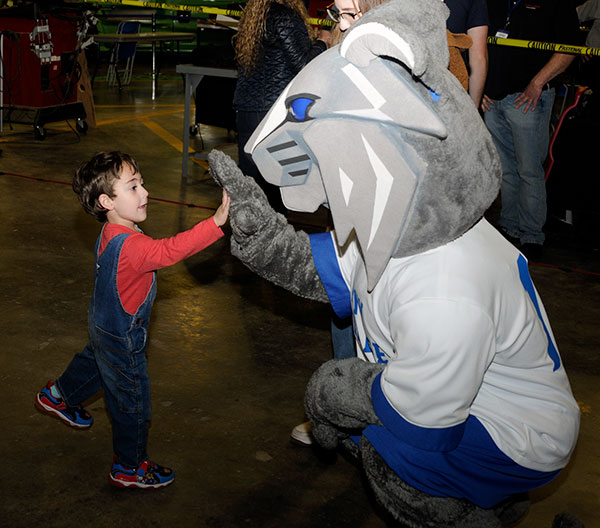 The Wildcat gets down to a young fan's level for some feline face time.