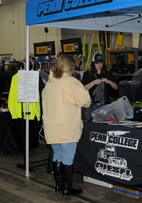 Marcayla M. Lutzkanin, of Port Carbon, who is adding a bachelor's to her two equipment-related associate degrees, completes a sale at the Diesel Performance Club pop-up. An active student who serves as club president and as a Wildcat cheerleader, Lutzkanin was a featured speaker at a dinner on the eve of competition.