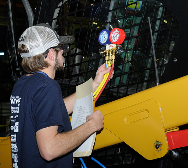 A student checks gauges at the Air Conditioning station.