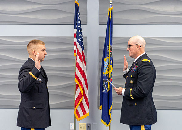 Army ROTC cadet Joshua E. Norris, of Gratz, Dauphin County (left), was commissioned as a second lieutenant during a ceremony at Pennsylvania College of Technology. The oath is administered by Lt. Col. Lance Shaffer, a Norris family friend.