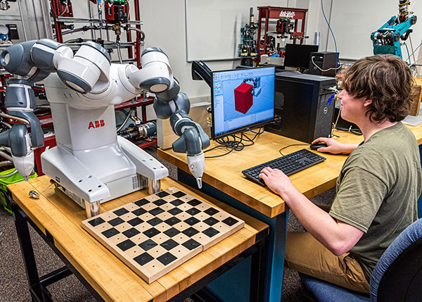 Pennsylvania College of Technology student Chandler P. Shatto, of Mount Pleasant Mills, uses software donated by ABB Robotics to program a YuMi dual-arm robot. The RobotStudio software is valued at over $400,000 and will be used by about 60 students per year. Shatto is seeking a bachelor’s degree in automation engineering technology: robotics & automation. 