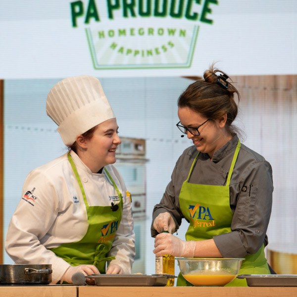 Landon shares an onstage laugh with Penn College alumna and “Chopped” television-series champion Kristina Wisneski, ’13, sous chef of Pure Roots Provisions in King of Prussia. Other alumni appearing on the Culinary Connection stage were Darren J. Layre ’15, executive chef of Alta Via Pizzeria in Pittsburgh, and Richard McGlynn III, ’13, baker at 40 North Bar & Restaurant, also in Pittsburgh.