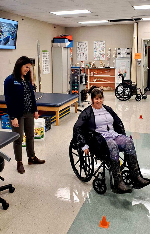 Kimberly S. Cordrey, Lumley Aviation Center secretary, appreciates the difficulty of maneuvering a wheelchair.