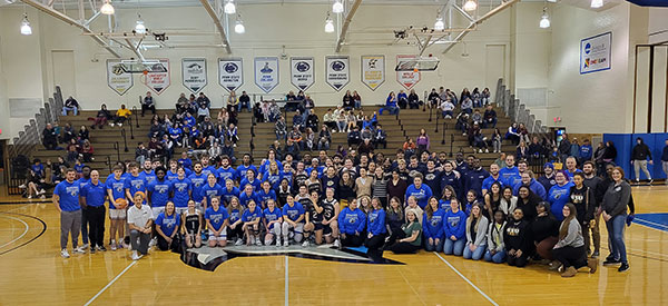 Both schools' teams, as well as all of the campus organizations involved in the special night, gather at midcourt between games. (The Wildcats prevailed in both contests, each by a five-point margin.)