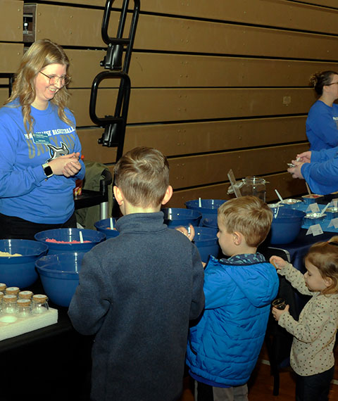 Calli R. Ackels, wellness education coordinator, was popular from the get-go, attracting these young sand artists.