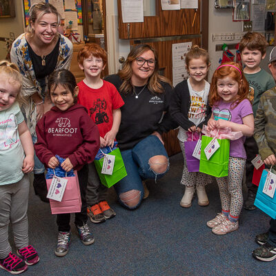 A bunch of “Birds” (ages 4 and 5) happily pose with the gift-giving honor students.