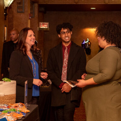 Alison A. Diehl, executive director of the college's Clean Energy Center, networks with Alix Norte (center), a community member who supports the Clean Energy Center's impactful programs, and Shaqira S. Drummond, a 2022 business administration: marketing concentration graduate who created promotional materials for Night of Empowerment.