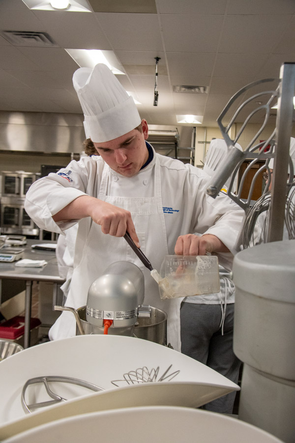 Student Carter P. Gordon adds ingredients for brioche. Gordon is from Lancaster.