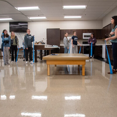 With Victoria Hurwitz, director of the physical therapist assistant program, high schoolers from Cumberland Perry Area Career & Technical Center incorporate their learning about nerves and muscles to come up with an exercise-band activity to target a specific area.