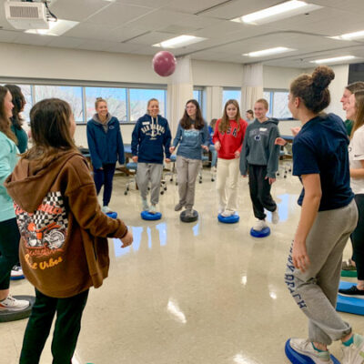 High schoolers test their own balance while learning how such activities are used in physical therapy. (Photo by Victoria Hurwitz, director of physical therapist assistant)