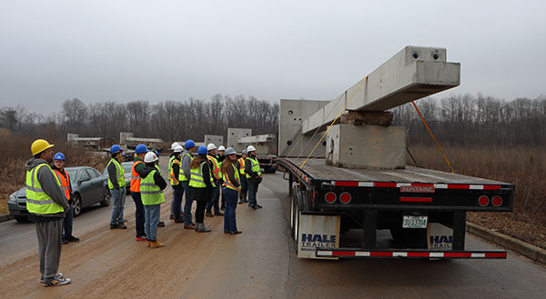 The project's scope is manifested in a trailer-to-trailer parade of precast concrete. 