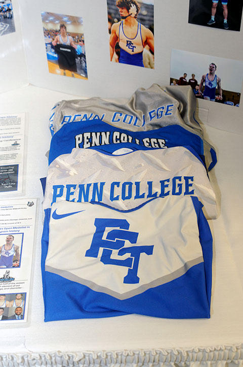 A nostalgic retrospective of Wildcat wrestling memorabilia – including a display of singlets from over the years – greets attendees of the weekend event.