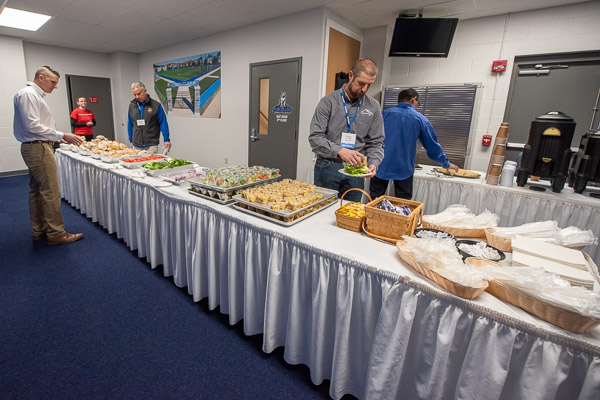 Employers enjoy a lineup of edible offerings in a corner of the Field House.