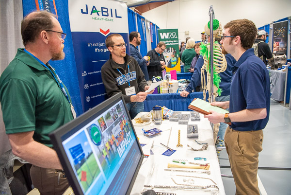 Bryan Harlacker (center), process engineer at Jabil Healthcare and a 2000 graduate of Penn College’s manufacturing engineering technology major, interviews Preston James Evey, an engineering design technology student from Lamar. Harlacker’s colleague, Mike Olsen, is at left. 