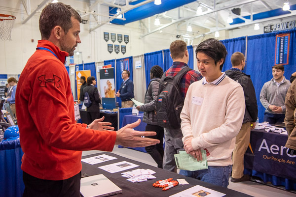 Allegheny Electric Service’s A.J. Straub (left) offers advice and options to Ricky M. Htay, an international student from Myanmar who is enrolled in mechatronics technology. 