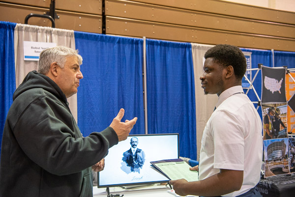 Bobst North America’s Gilberto Ramos (left) enjoys his interaction with Joseph A. Jegede, an electronics & computer engineering technology student from West Chester.