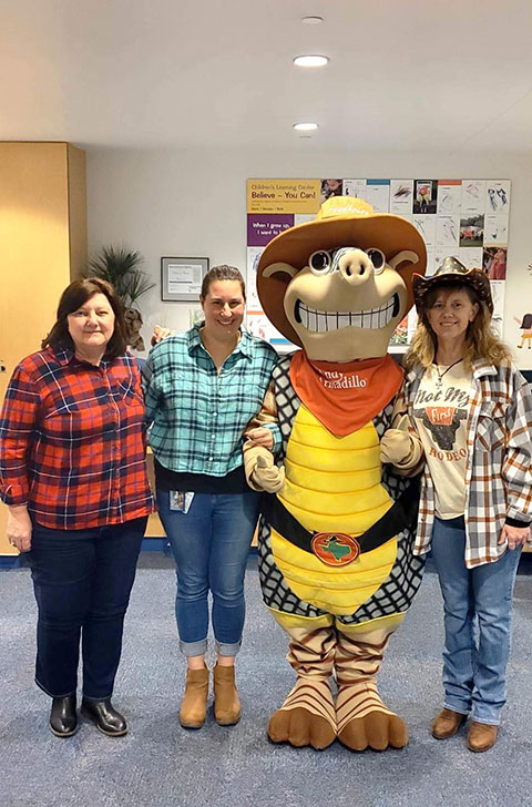 Andy joins western-clad friends (from left) Darlene A. Warner, CLC operations assistant; Stacie L. Smith, who teaches the center's 2-year-olds; and director Linda A. Reichert.