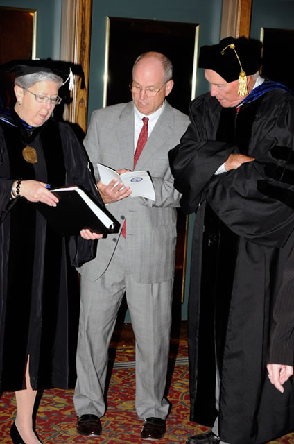 Barry R. Stiger, vice president for institutional advancement, talks with President Gilmour and Chairman Dunham.