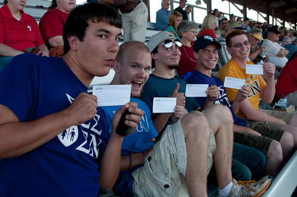 Chosen for between-inning games, Sigma Nu brothers show off their tickets.