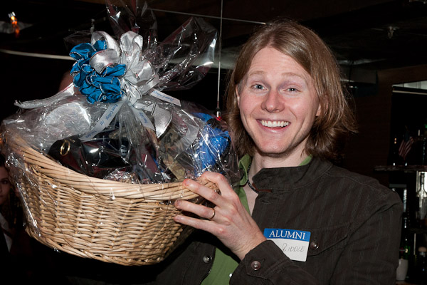 Nick Biddle holds the alumni gift basket he won at the Bullfrog.