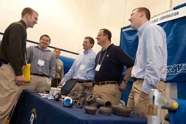John T. McCormack, left, manufacturing engineering technology senior from Brookville, shares a laugh with four employees from Bonney Forge Corp., including 2010 computer aided product design alumnus Timothy R. Harrigan, to McCormack's left.