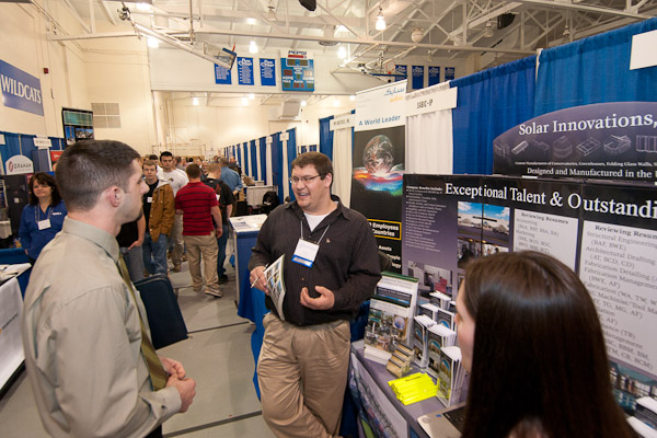 Illuminating alumnus Louis A. "Chip" Rizzo III, center, '08, building construction technology and '10, residential construction technology and management: building construction technology concentration, with Solar Innovations, Inc., talks business with Corvin K. Oberholtzer, a senior in residential construction technology and management, from Wellsboro.