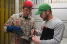 Alumnus Adam Steppe, right, inspects a weld during the postsecondary contest