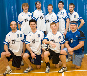 The alumni volleyball gathers for a group photo after victory in its inaugural outing.